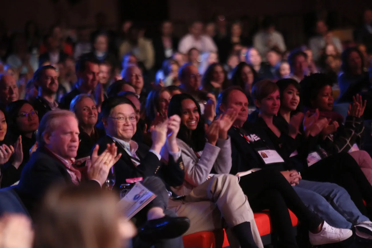 The audience in a reverse shot, lit for the camera without light in their eyes