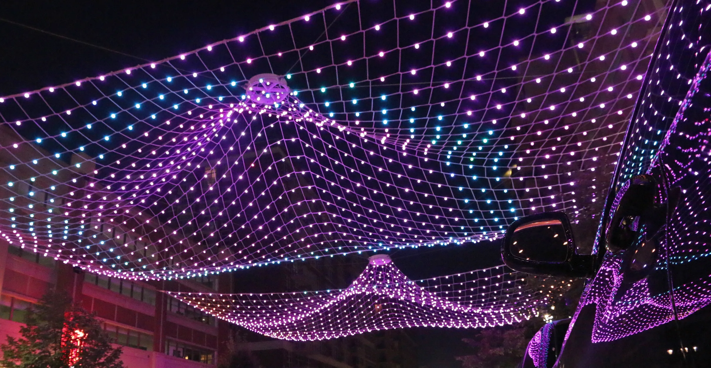 Standing Wave at night: points of light in waves of wire mesh above Fleet Street